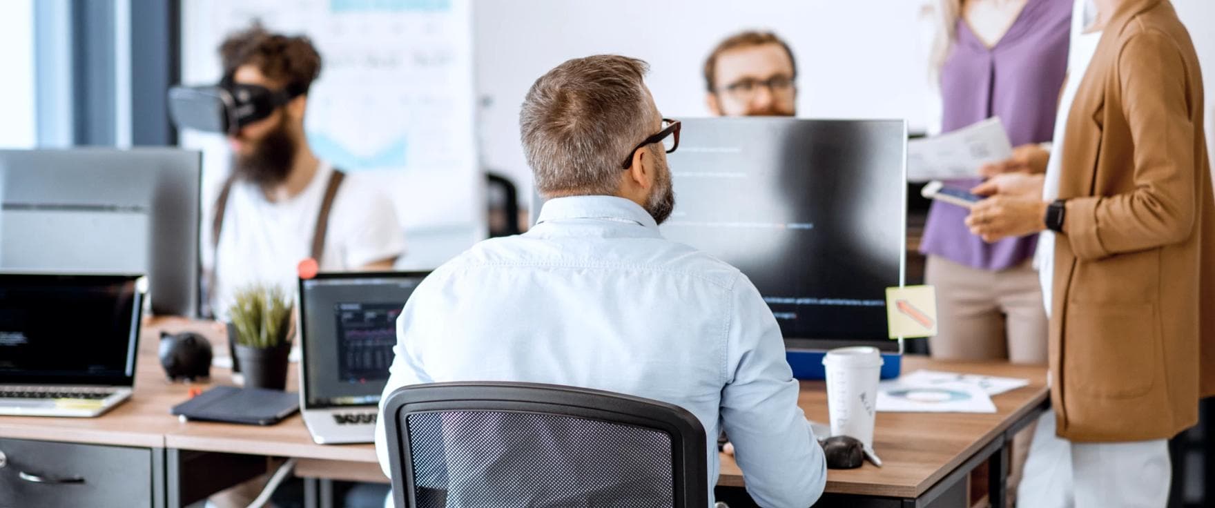 Five office workers with computers