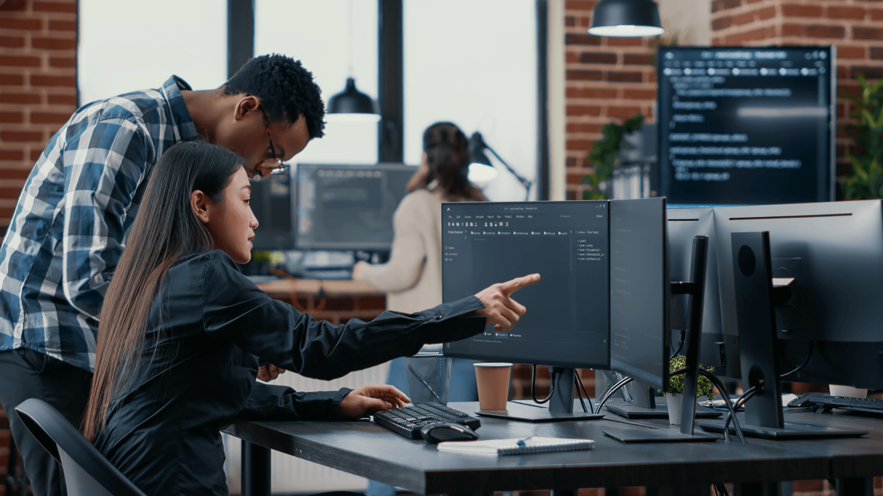 Woman and man working at a desktop