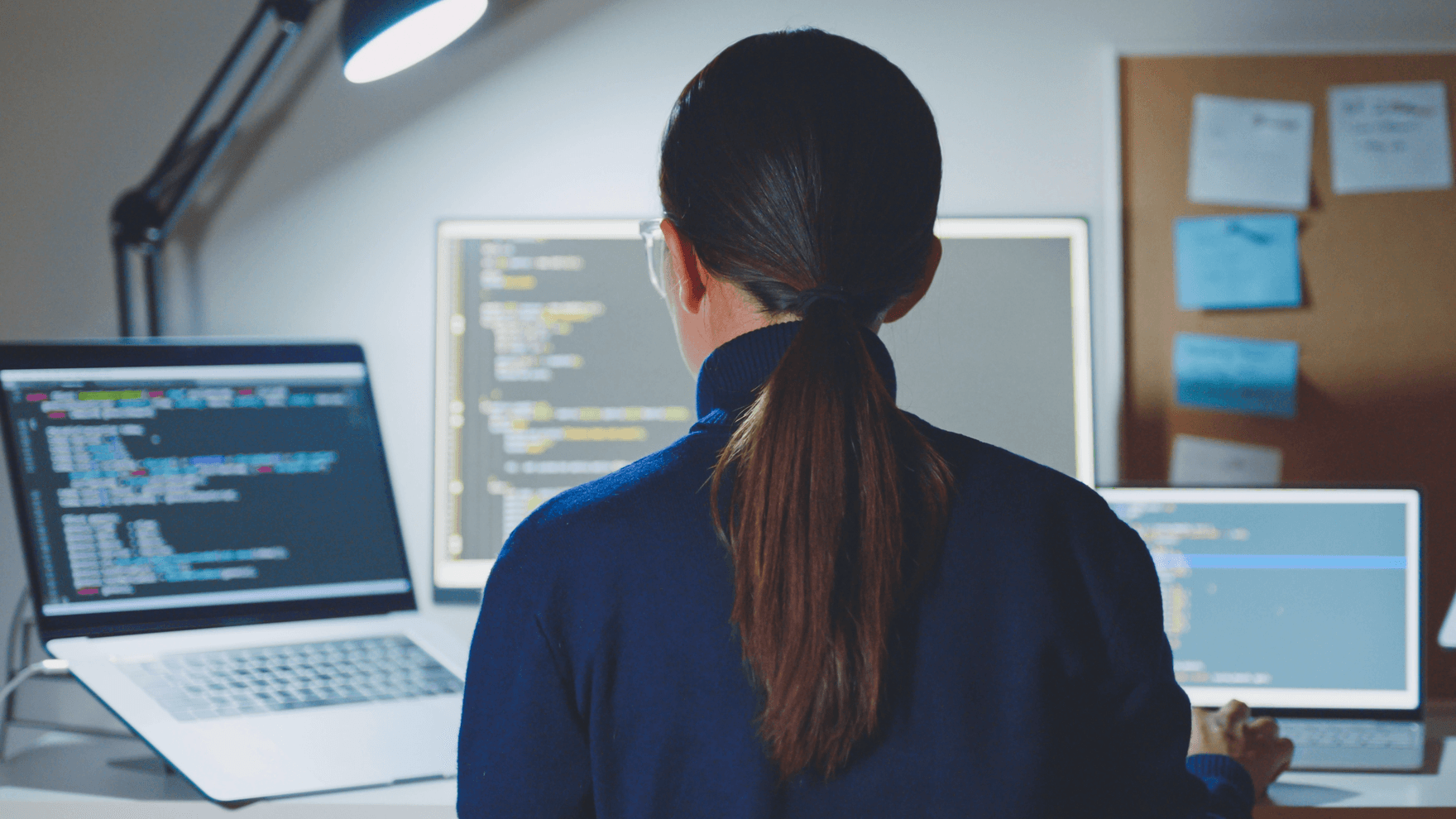 Woman working with two computers