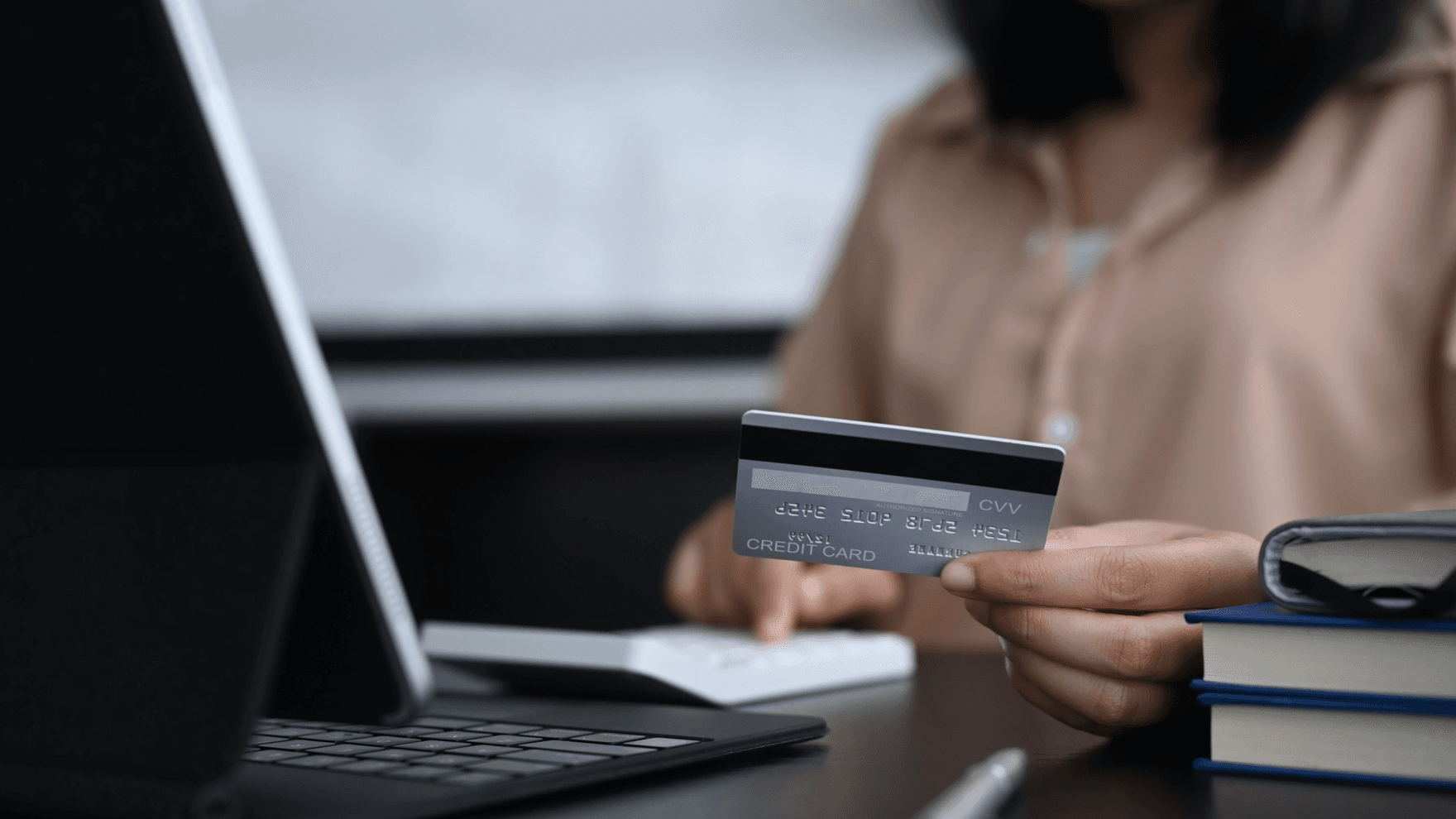 Woman holding a credit card while online shopping