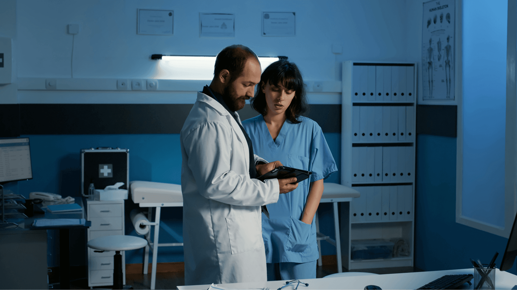 Two doctors looking at a tablet