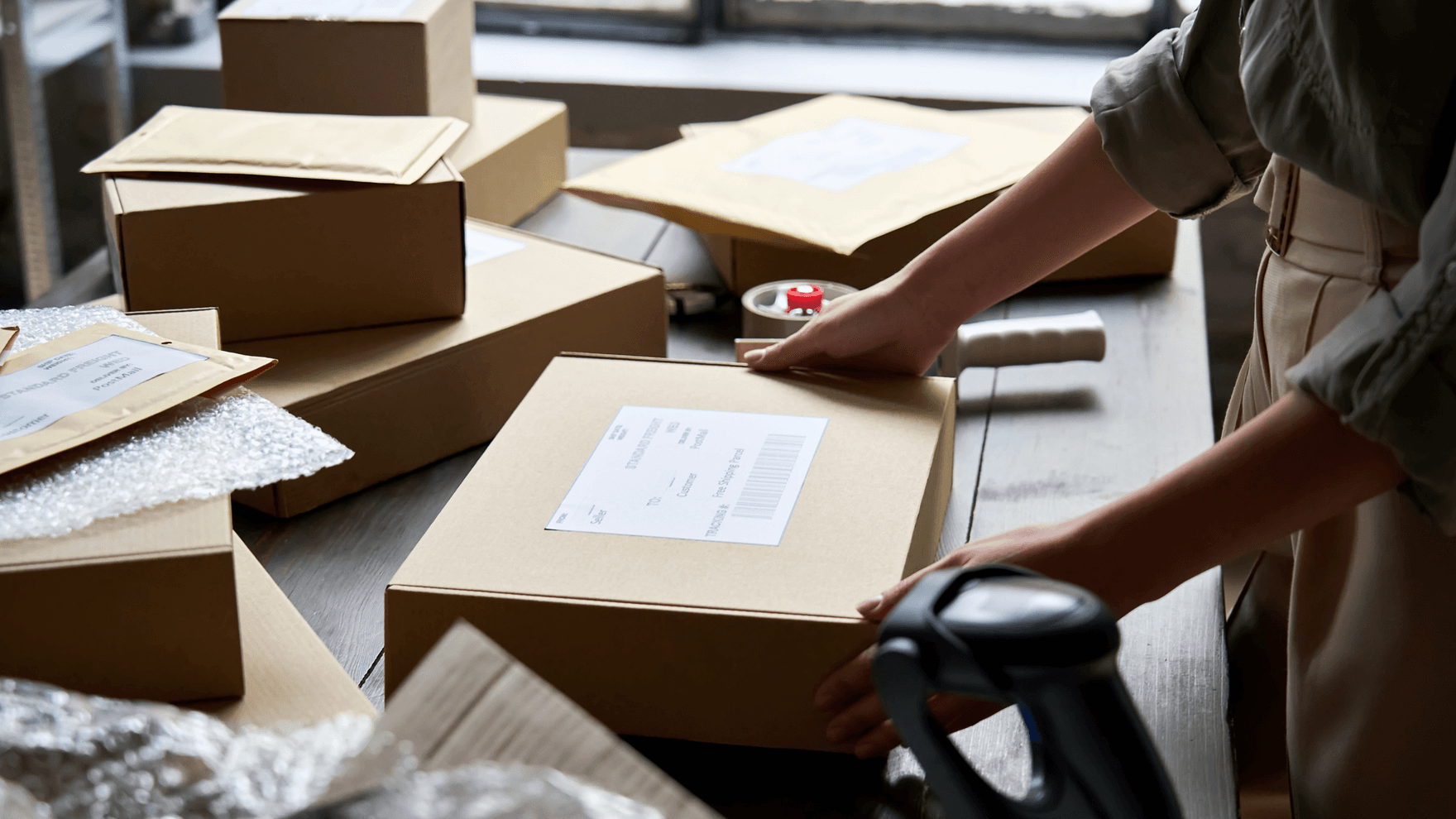 A woman preparing ecommerce packages