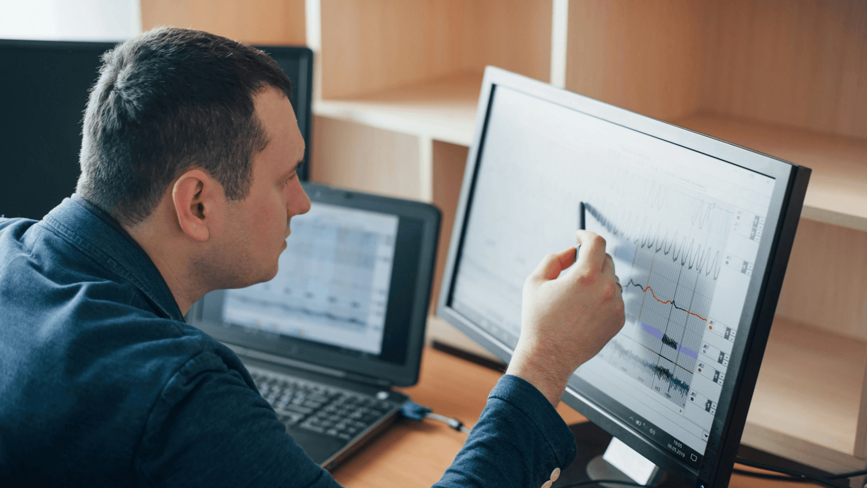 A man analyzing data on his computer