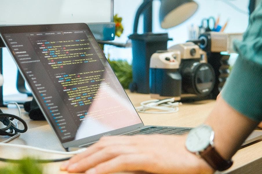 A laptop with code being written on the screen