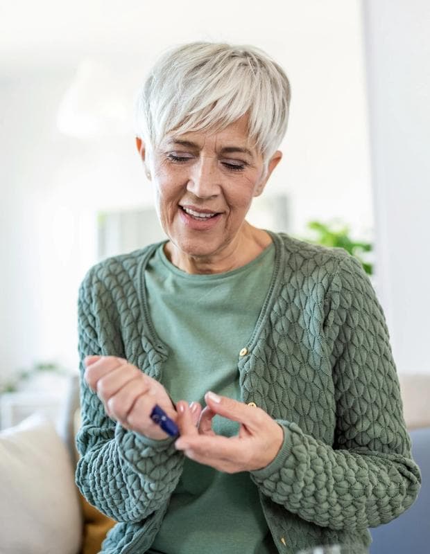 Woman monitoring blood sugar