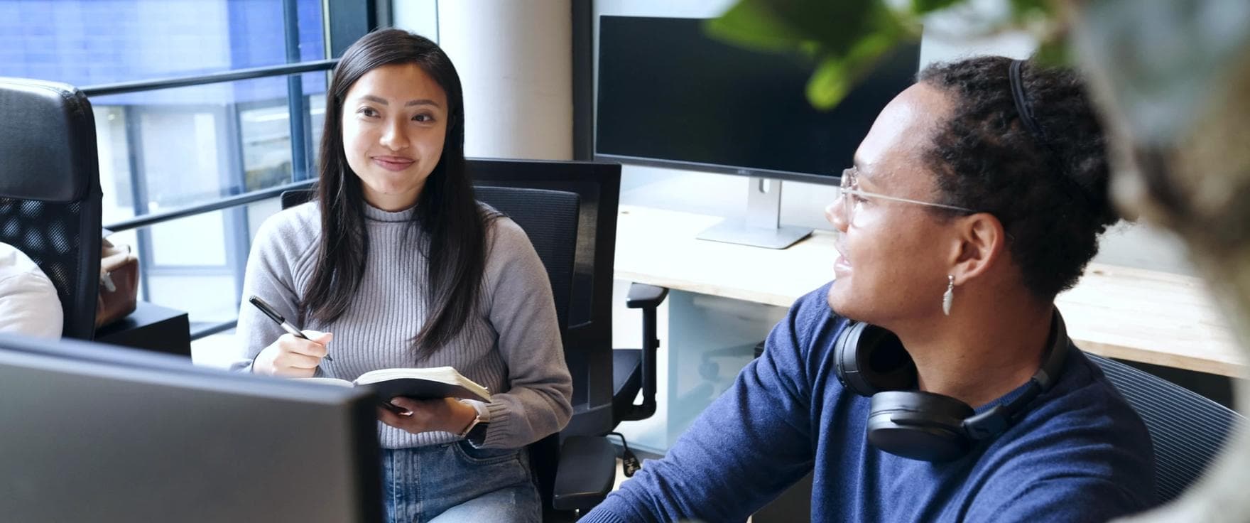 Two office workers in tech environment