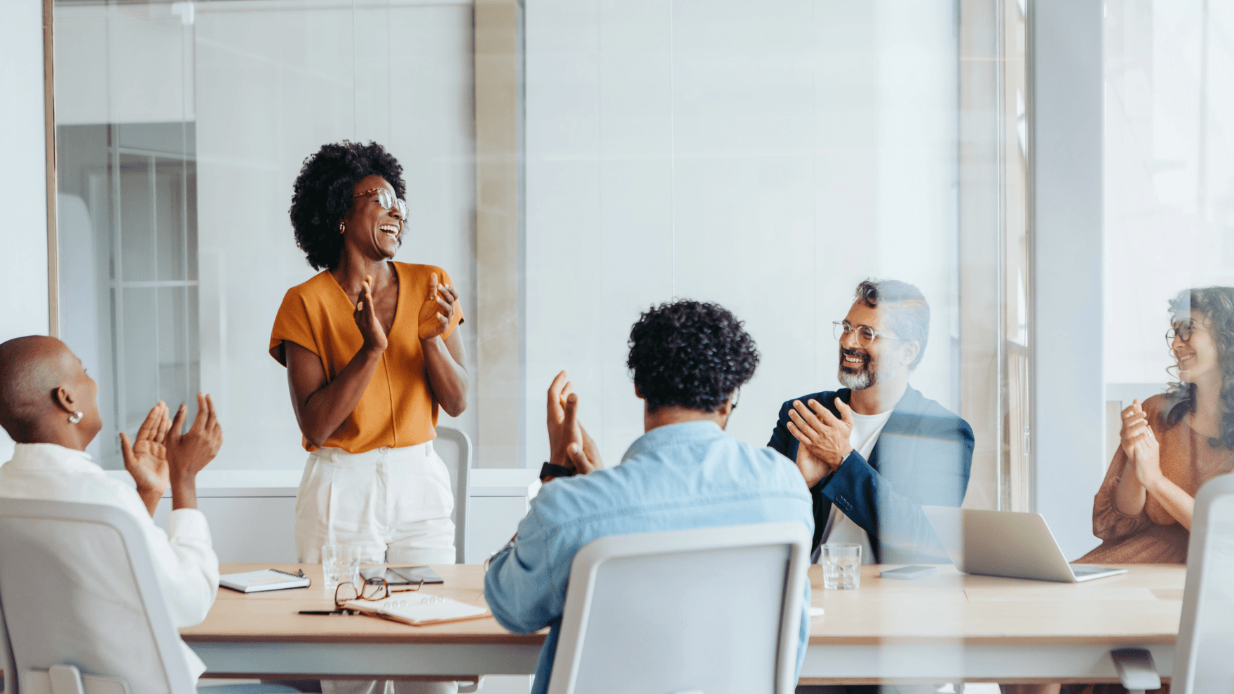 Successful business meeting with a creative team applauding their colleagues' project