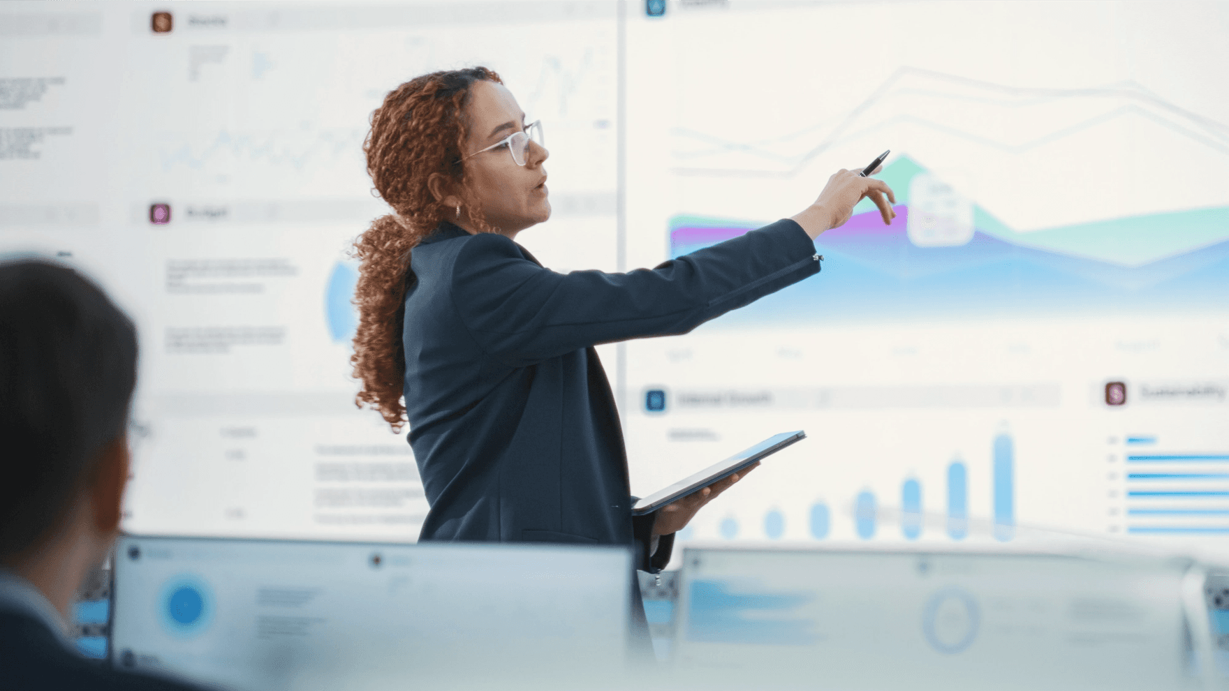 Woman analyzing data on big screen