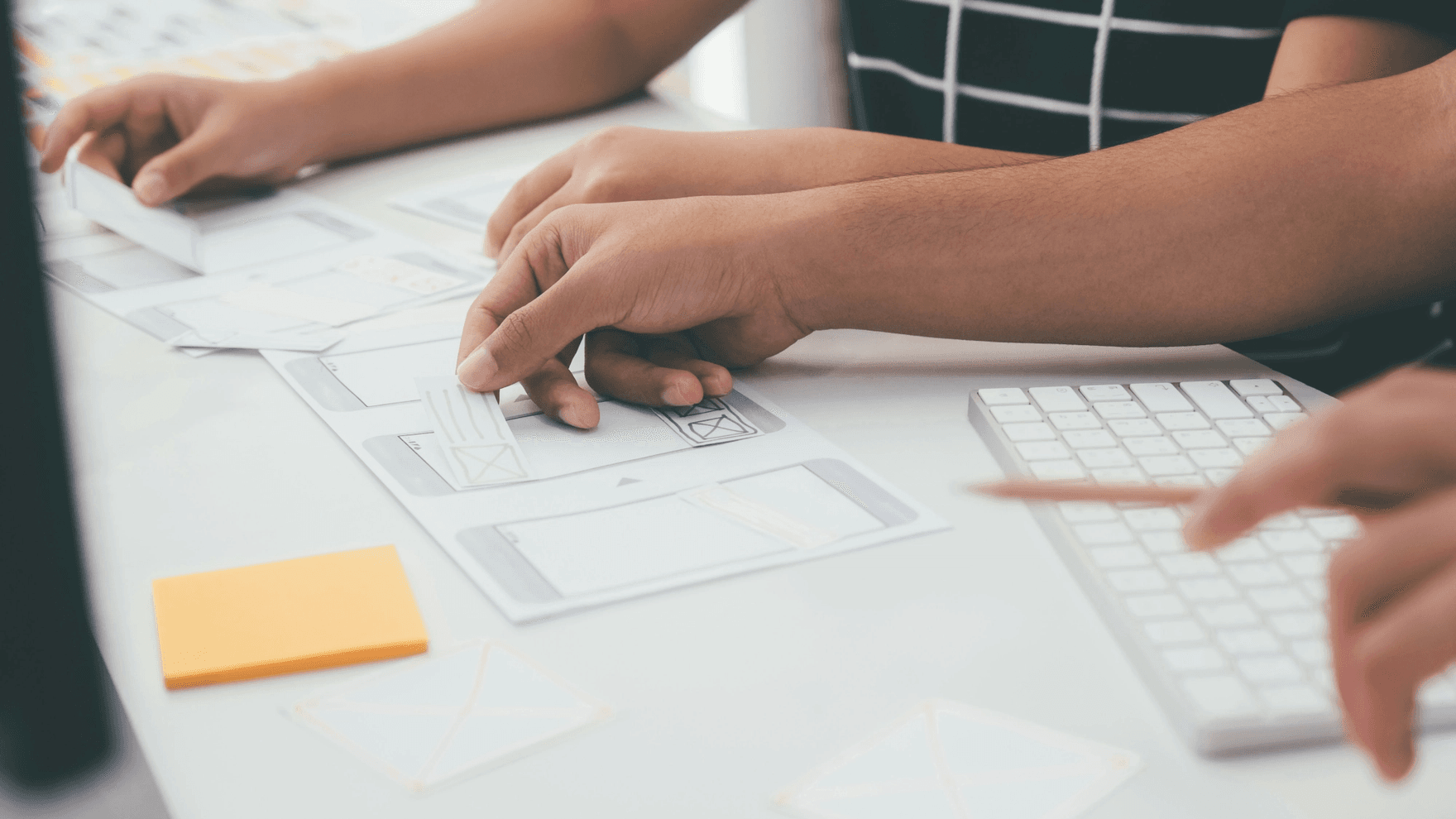 The hands of two ux designers testing wireframes