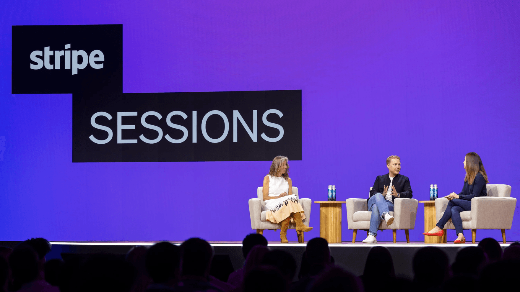 3 People debating on stage at Stripe event