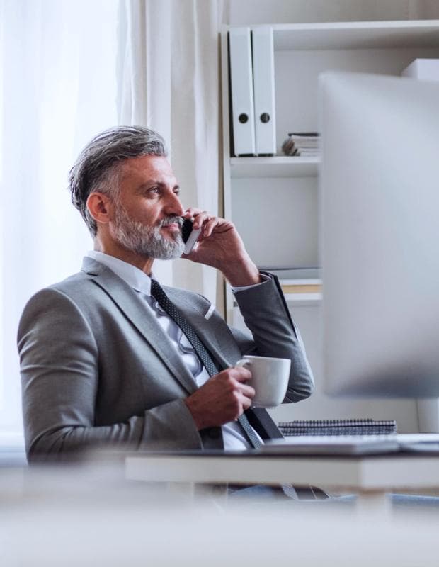 Lawyer speaking on the phone with cup of coffee