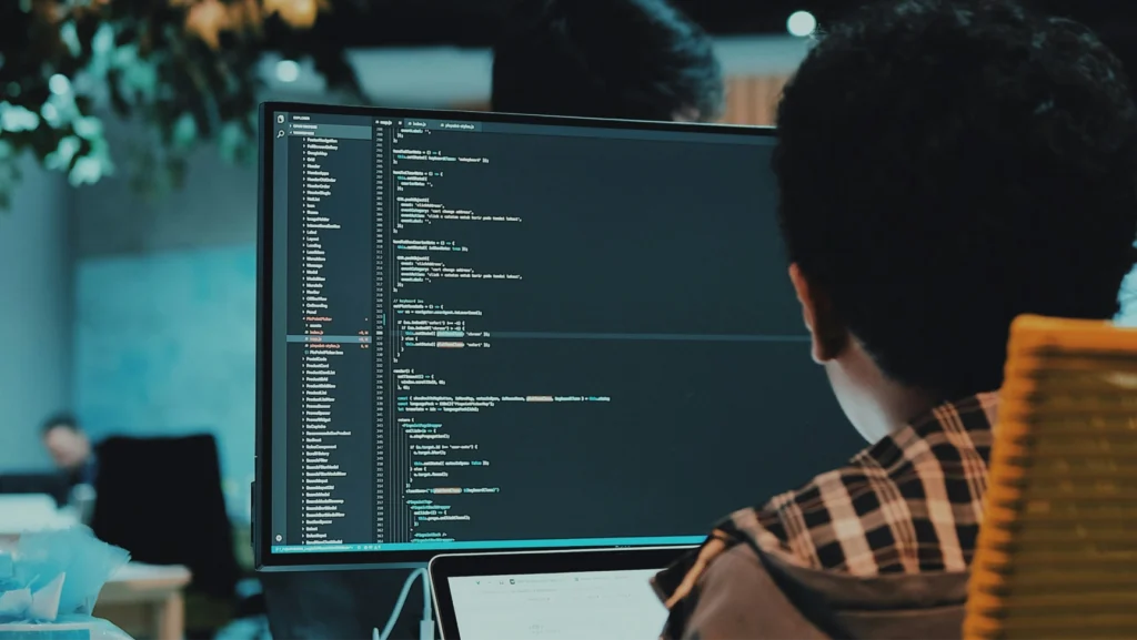A laptop with code being written on the screen