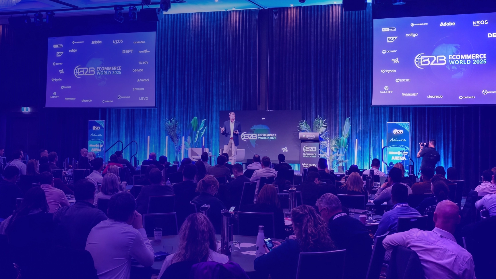 Keynote speaker presenting at B2B Ecommerce World 2025 conference to a packed audience, showcasing global eCommerce insights and industry innovation.