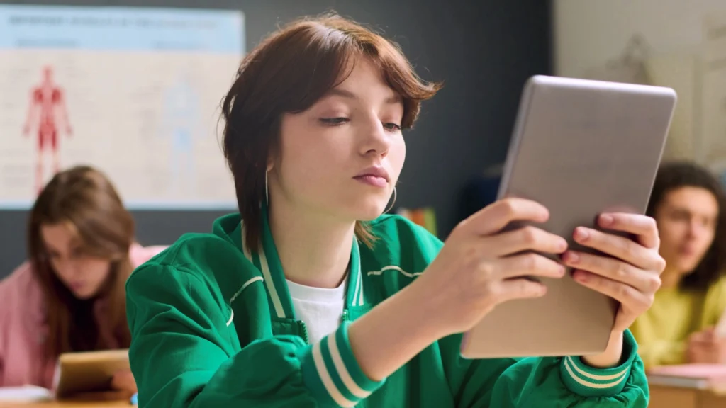 Girl looking at ipad in classroom
