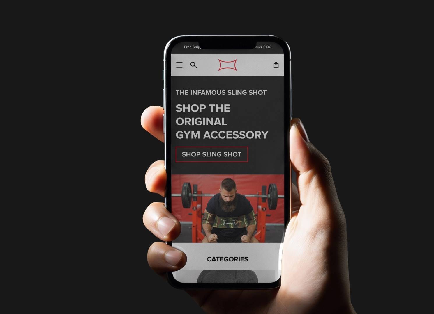 Hand holding phone with Mark Bell Sling Shot homepage