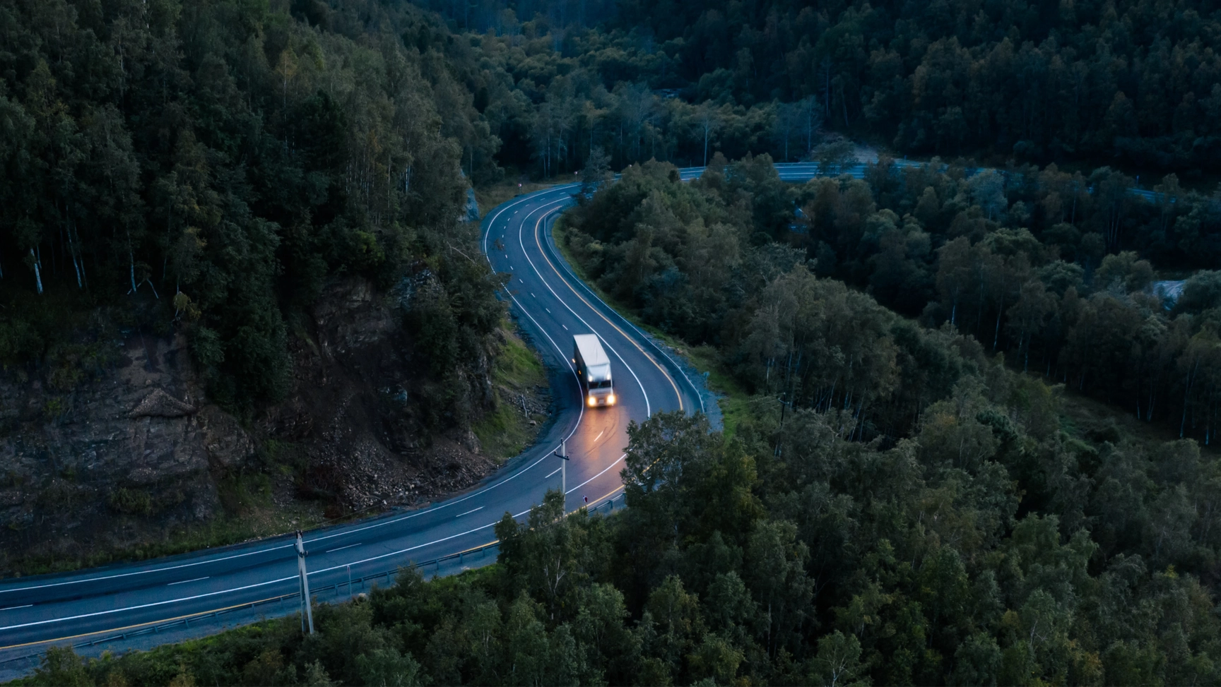A truck driving down a highway
