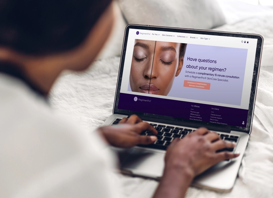 Woman scrolling the RegimenPro website on a laptop