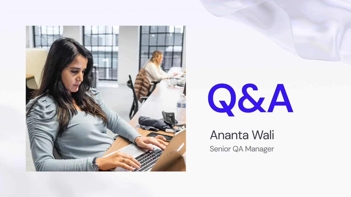 Ananta Wali, QA Manager, working on her laptop in the office