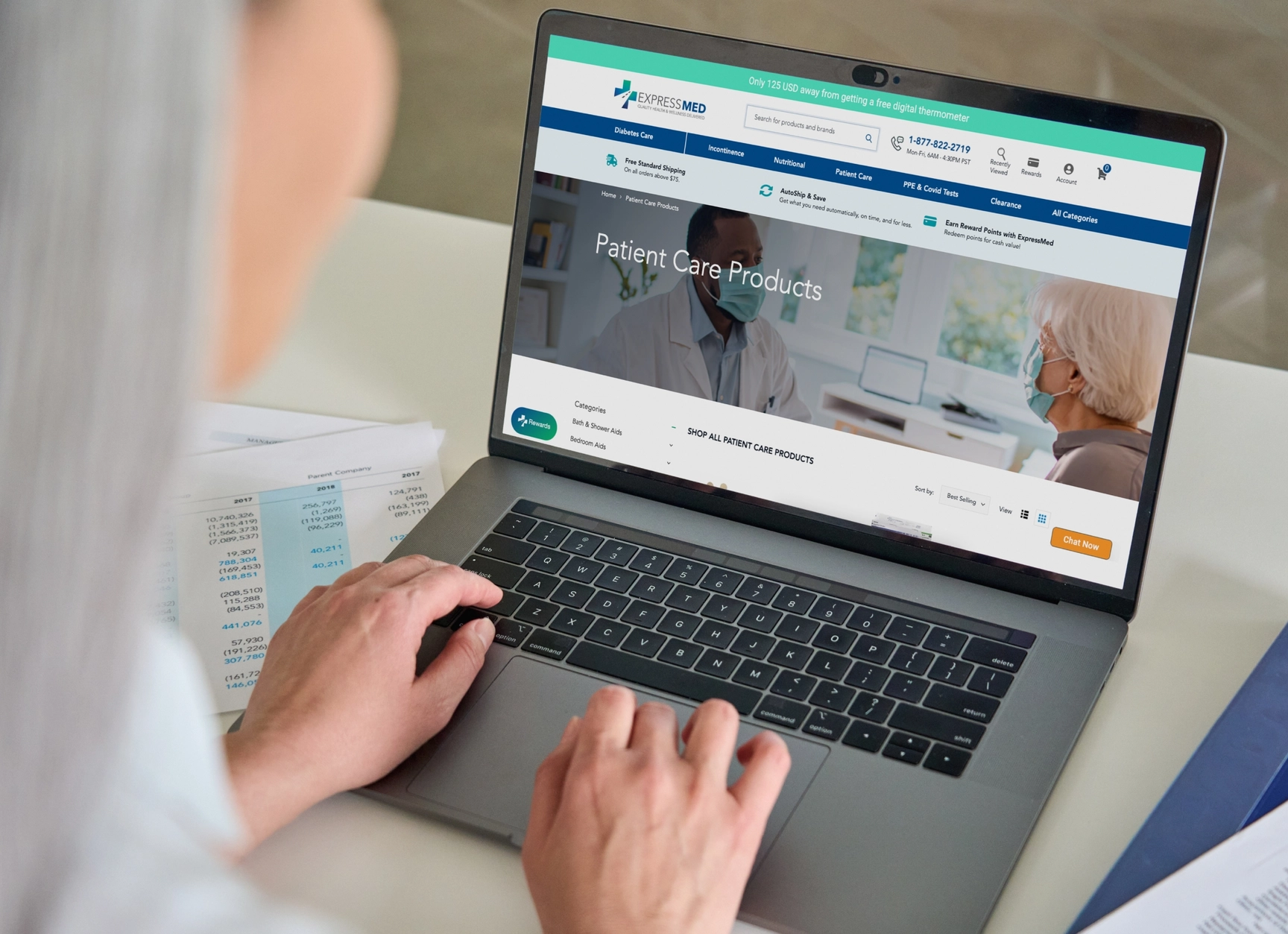 Doctor scrolling through ExpressMed homepage on laptop