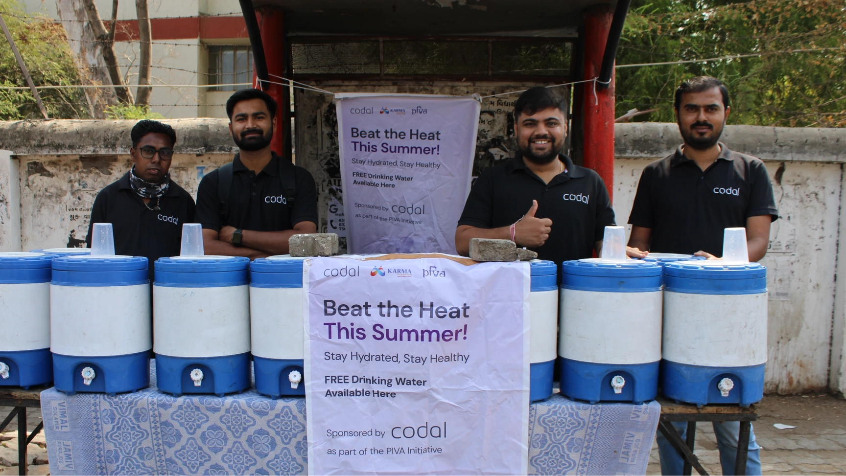 Codal employees participating in a "Beat the Heat This Summer!" campaign, distributing free drinking water to the public.