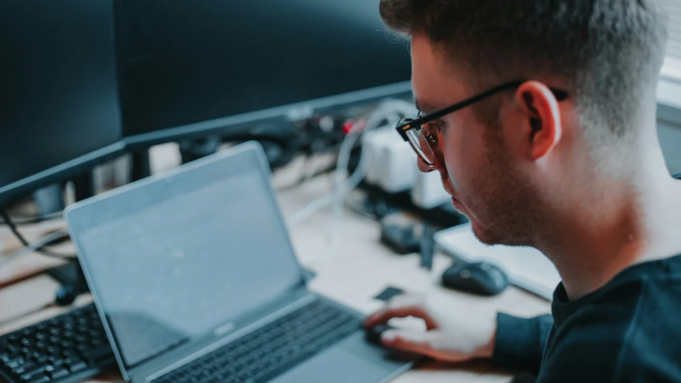 Dedicated startup engineer or developer focused on debugging, user testing, and ensuring high-quality software performance on a laptop in an accelerator environment.