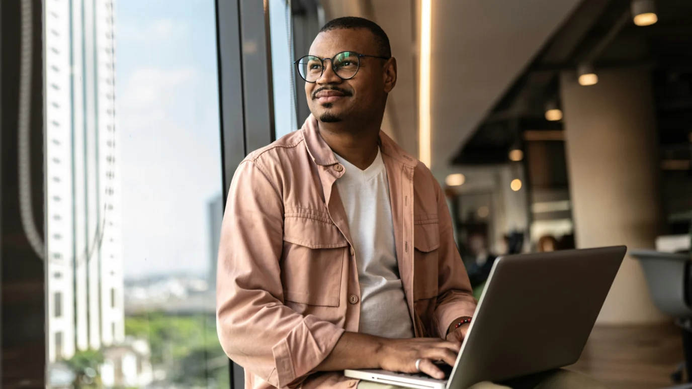 B2B Corporate man with laptop smiling